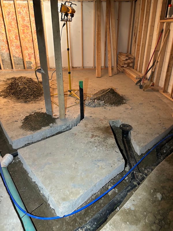 Basement renovation plumbing rough-in with new water line trench