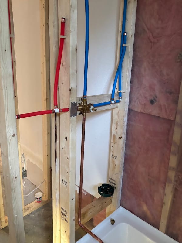 New PEX and copper shower rough-in inside wall framing